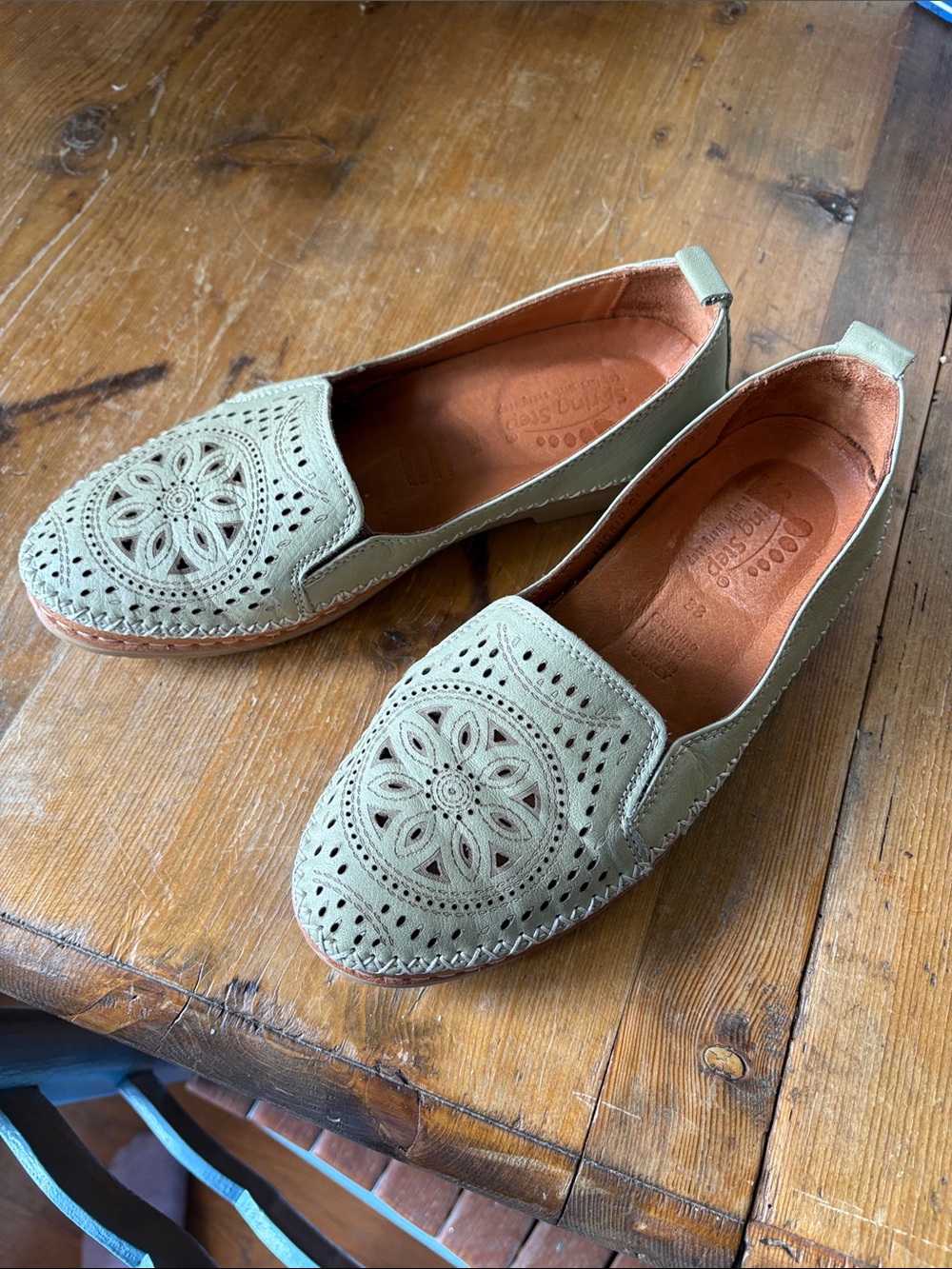 Spring step Sage Green Slip-Ons with intricate design.